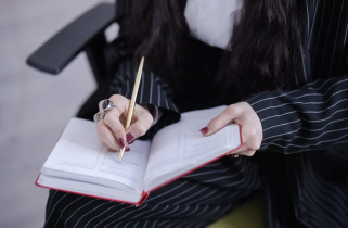 Woman Writing on a Notebook